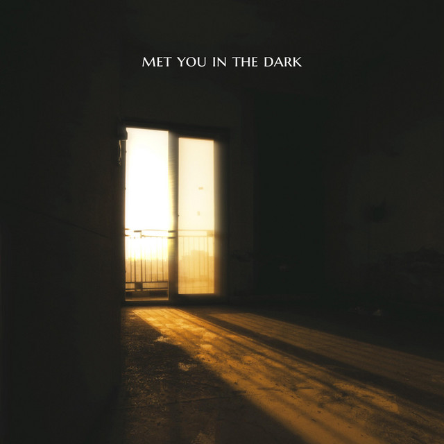 Single artwork for Met You In The Dark: golden sunlight pours through a glass door into a dark, empty room.