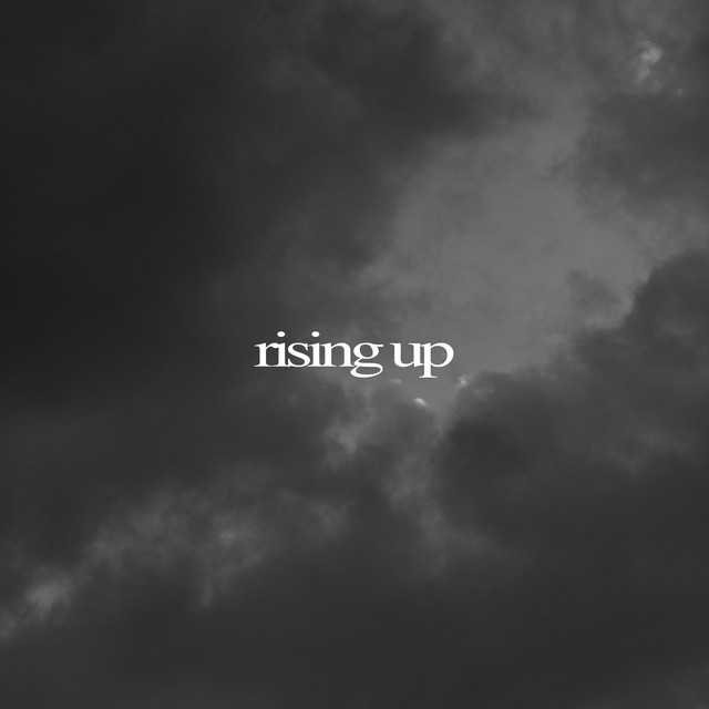 Single artwork for Rising Up: the words rising up in white over dark storm clouds.