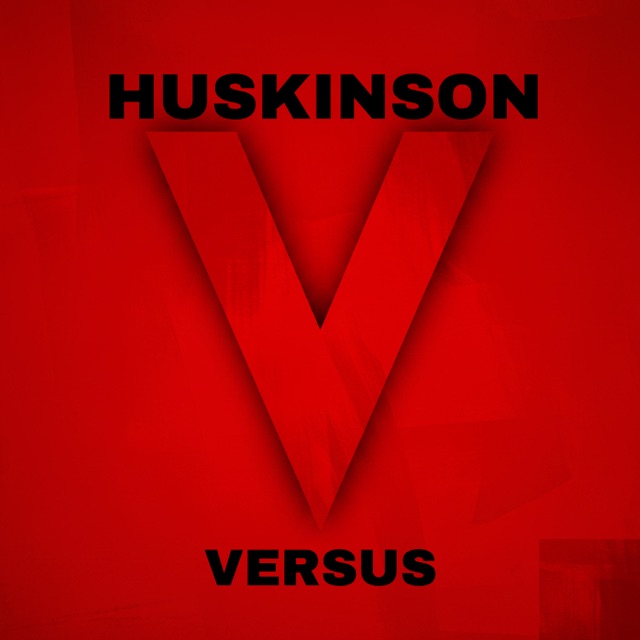 Artwork for the Versus EP: a huge dark red letter V on a bright red background, with HUSKINSON in black above and VERSUS in black below.